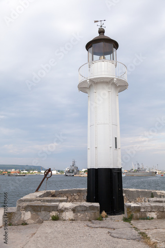 Wallpaper Mural White lighthouse tower with black base is under blue sky on a daytime Torontodigital.ca