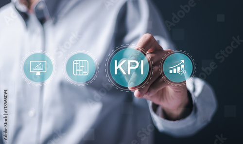 KPI Business analytics. Businessman touch virtual icon of data analytics report and Key Performance Indicators on information dashboard for business strategy and business intelligence.
