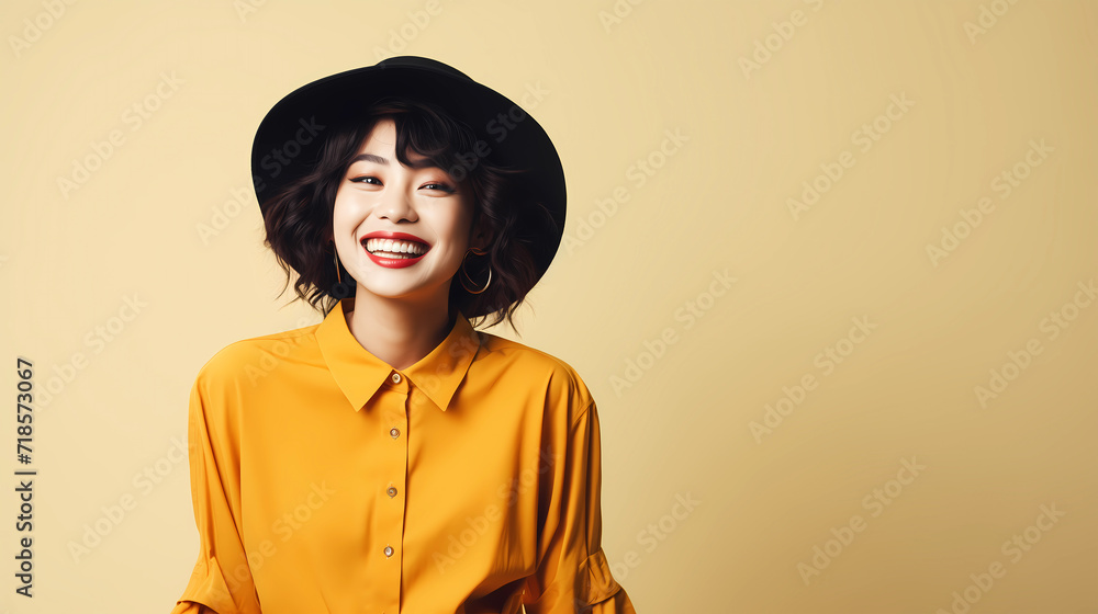A happy beautiful Asian woman wearing yellow shirt and yellow hat. Studio photo concept of selfie and happy expressions A happy beautiful Asian woman wearing yellow shirt and yellow hat. Studio photo concept of selfie and happy expressions