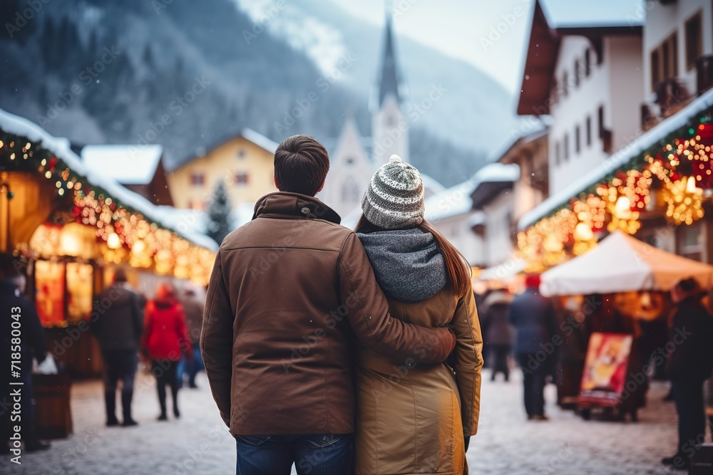 Couple visiting a small town market in the Alps, rear view of a couple visiting a Christmas market, Christmas market in the European Alps, market in a European town in winter