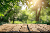 Empty wooden table top in a blurred green garden background