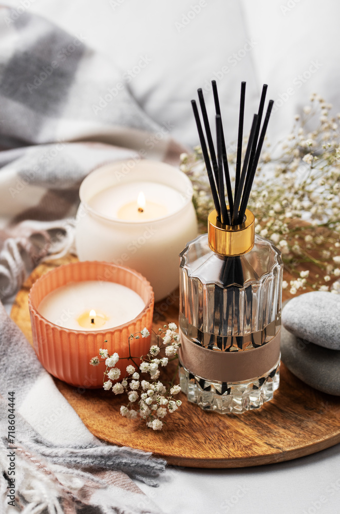 Cozy home atmosphere. Home liquid fragrance in glass bottle Cozy home atmosphere. Home liquid fragrance in glass bottle