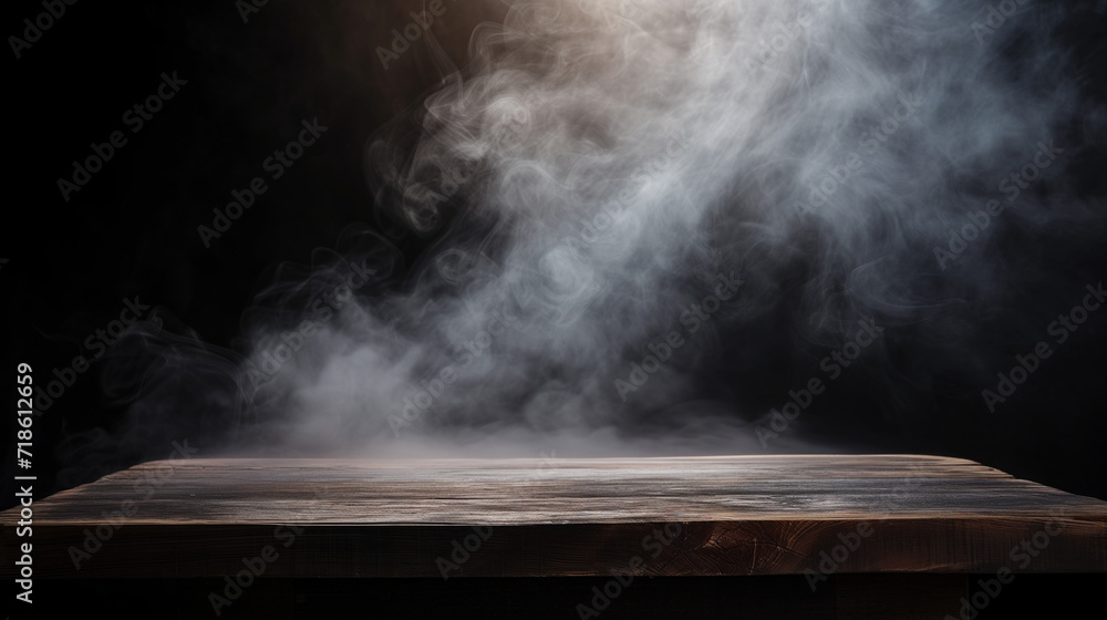 On a black background, an empty wooden table with smoke floats up. Empty space for displaying your products, with a smoke float up on a dark background.