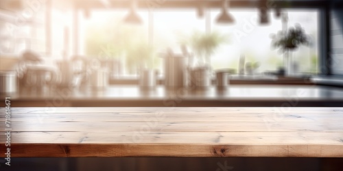 Blurred kitchen interior reflected on empty wooden table texture. © Sona