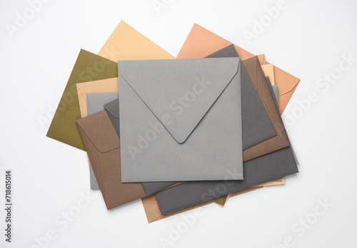 Stack of colored envelopes on white background