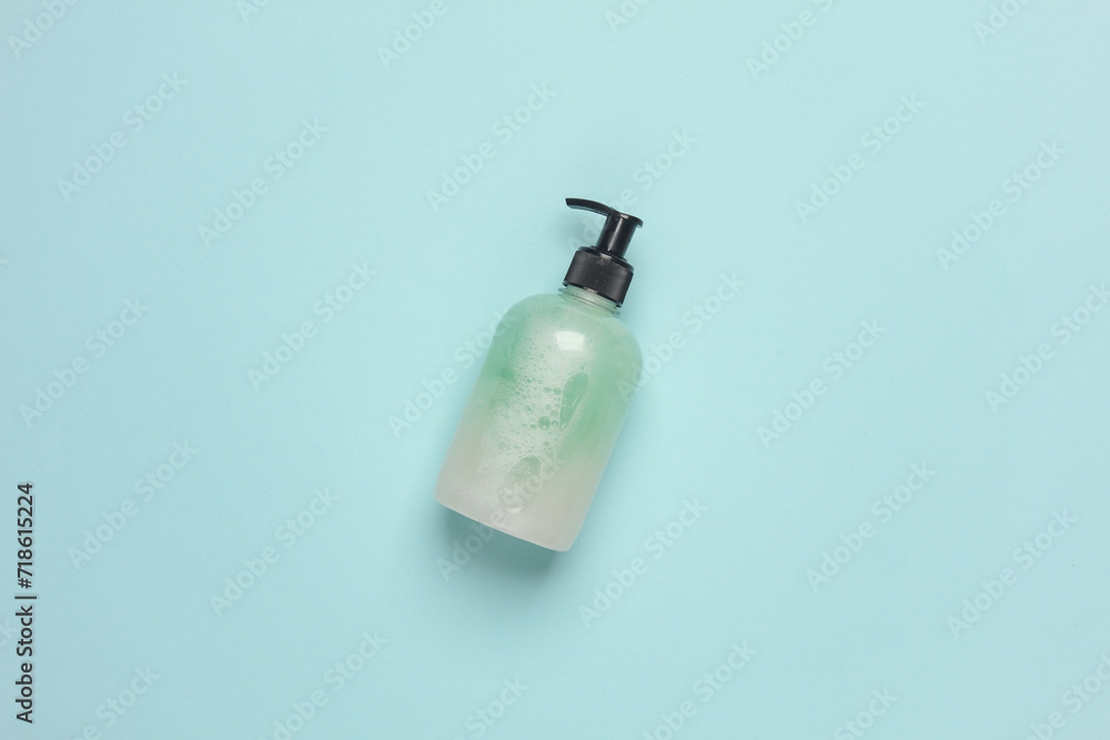 Bottle of liquid soap with dispenser on blue background Bottle of liquid soap with dispenser on blue background