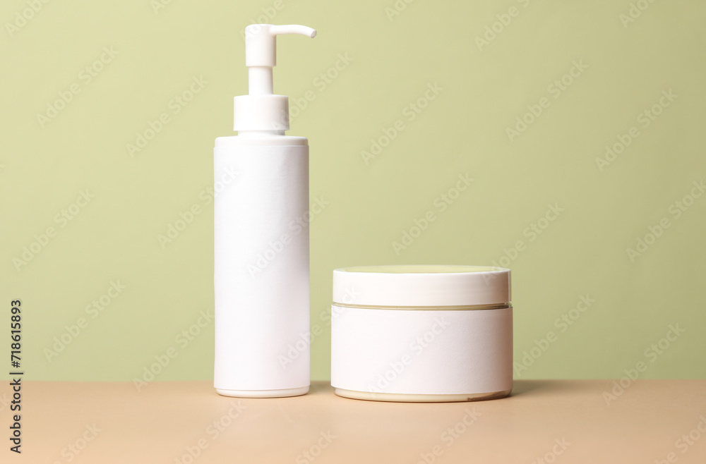 Bottles of cosmetics on a green background Bottles of cosmetics on a green background