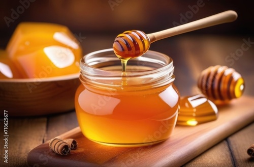 Honey with wooden honey dipper on wooden table.