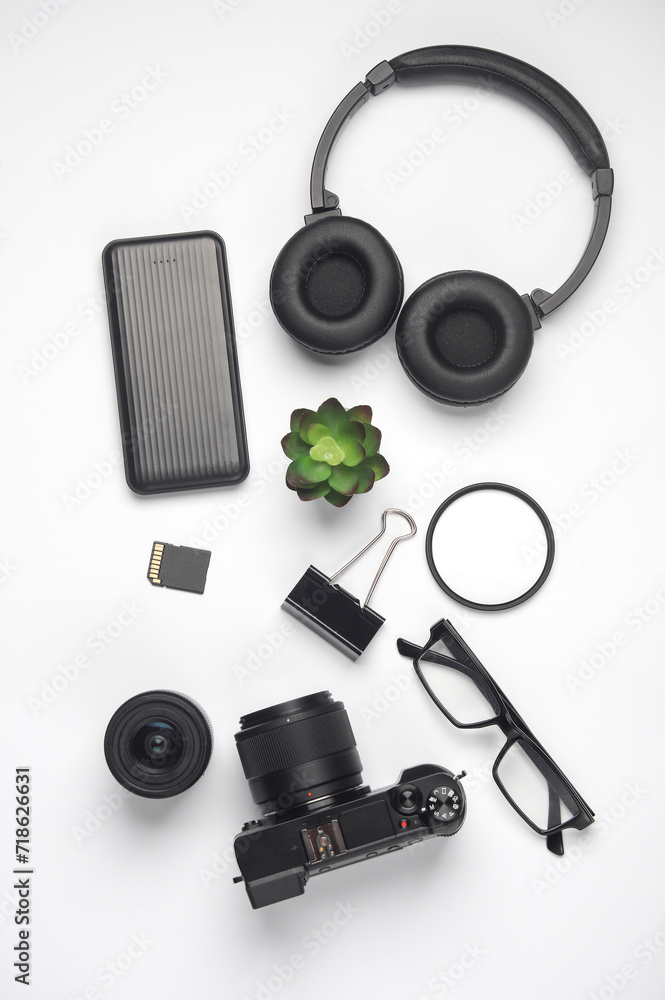 Modern gadgets on a white background Camera, power bank, headphones and accessories. Flat lay. Top view Modern gadgets on a white background Camera, power bank, headphones and accessories. Flat lay. Top view