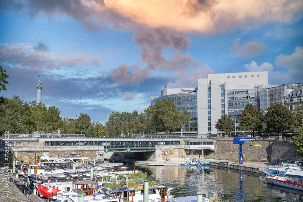 Paris, Bastille, beautiful harbor with houseboats, and typical facade in background
Paris, Bastille, beautiful harbor with houseboats, and typical facade in background