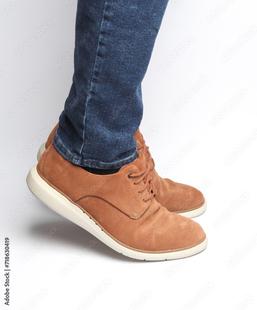 Male legs in suede shoes on a white background Male legs in suede shoes on a white background