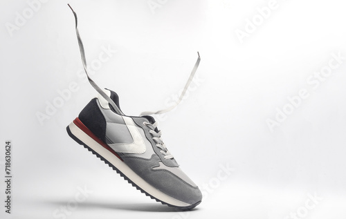 Sport sneakers with flying laces on a white background