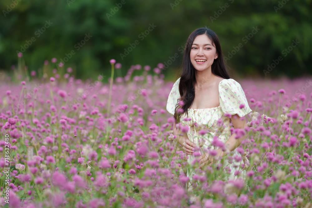 beautiful woman in dress enjoying blooming pink globe amaranth or bachelor button field beautiful woman in dress enjoying blooming pink globe amaranth or bachelor button field