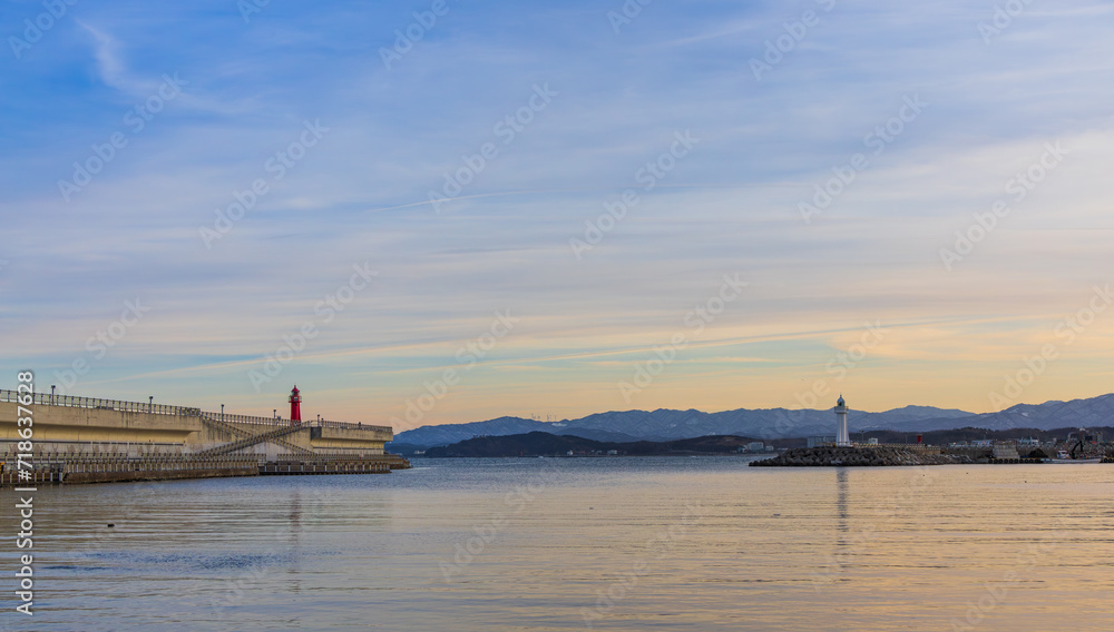 Port scenery with a beautiful sunset - Breakwater and lighthouse