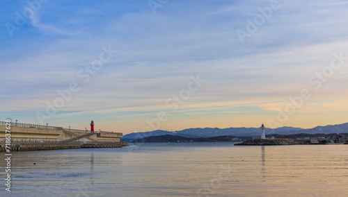 Port scenery with a beautiful sunset - Breakwater and lighthouse © two K