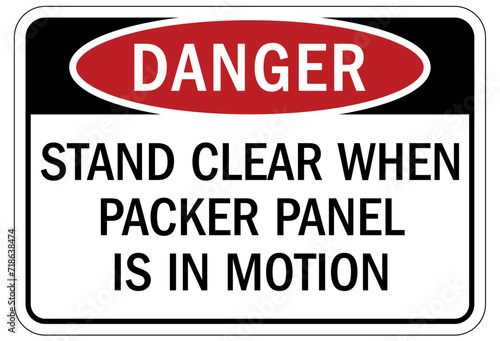Truck warning sign and labels stand clear when packer panel is in motion