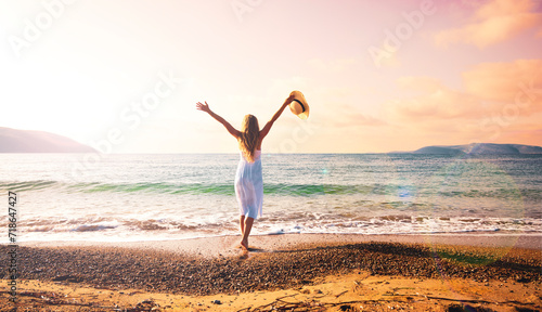 Woman in white dress enjoying freedom on the sea