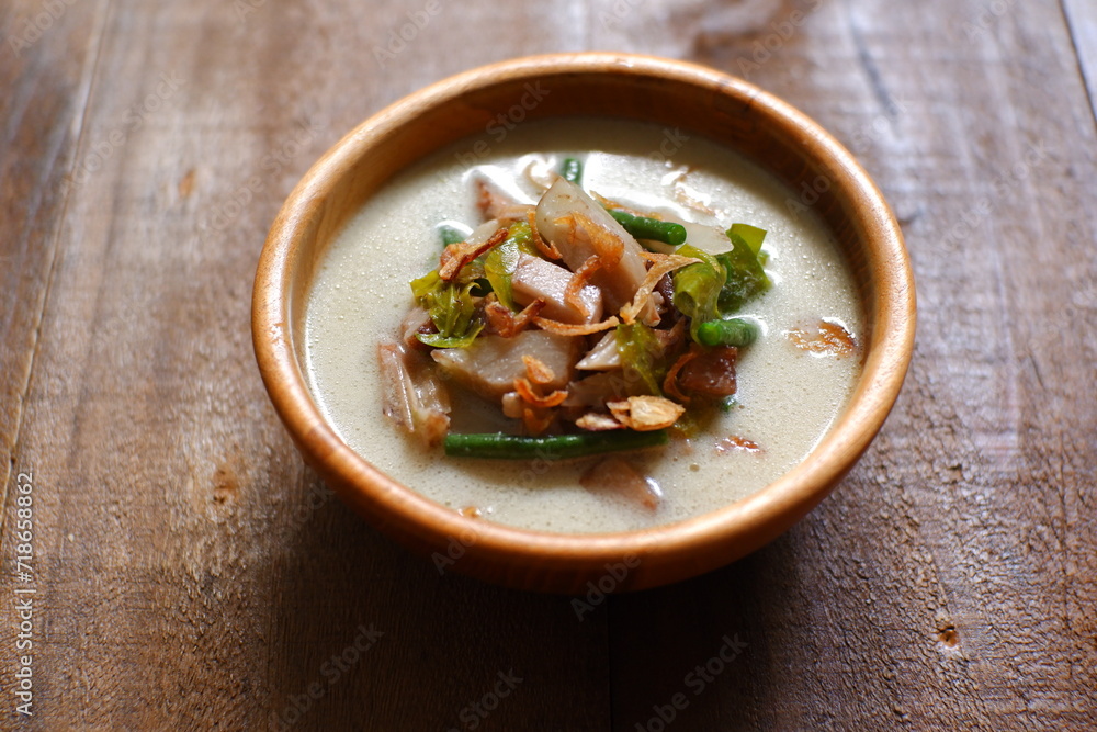 a bowl of sayur nangka muda in wooden background a bowl of sayur nangka muda in wooden background