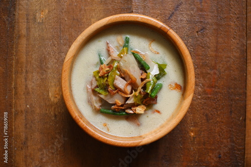 a bowl of sayur nangka muda in wooden background  photo