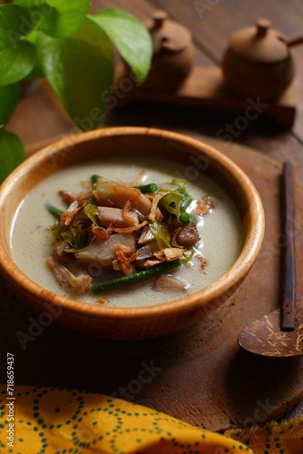 a bowl of sayur nangka muda on a wooden bowl