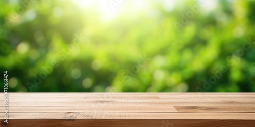 Wooden tabletop with green blurred background - ideal for product display or montage.