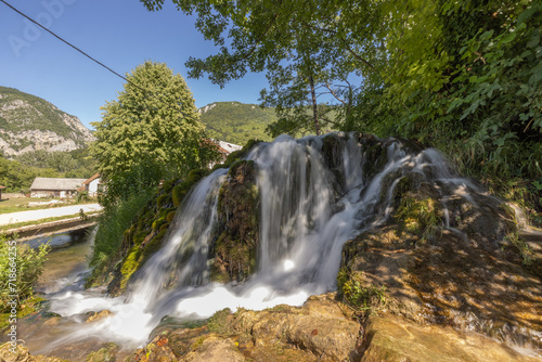 Small waterfalls on Una river, close to Martin Brod, Bosnia, on a summer day. Beautiful green river in a valley, with cascades and small waterfalls flowing.