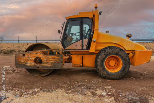 Steamroller performing road paving works