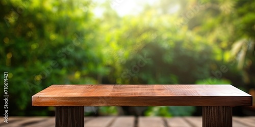 Vertical wooden table with blank space for your product or advertising text against blurred natural background.