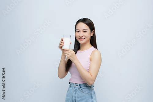 young girl holds glass of milk