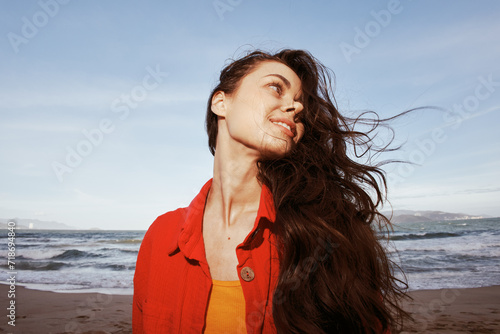 Smiling Woman Embracing Freedom and Joy on a Red Beach Vacation