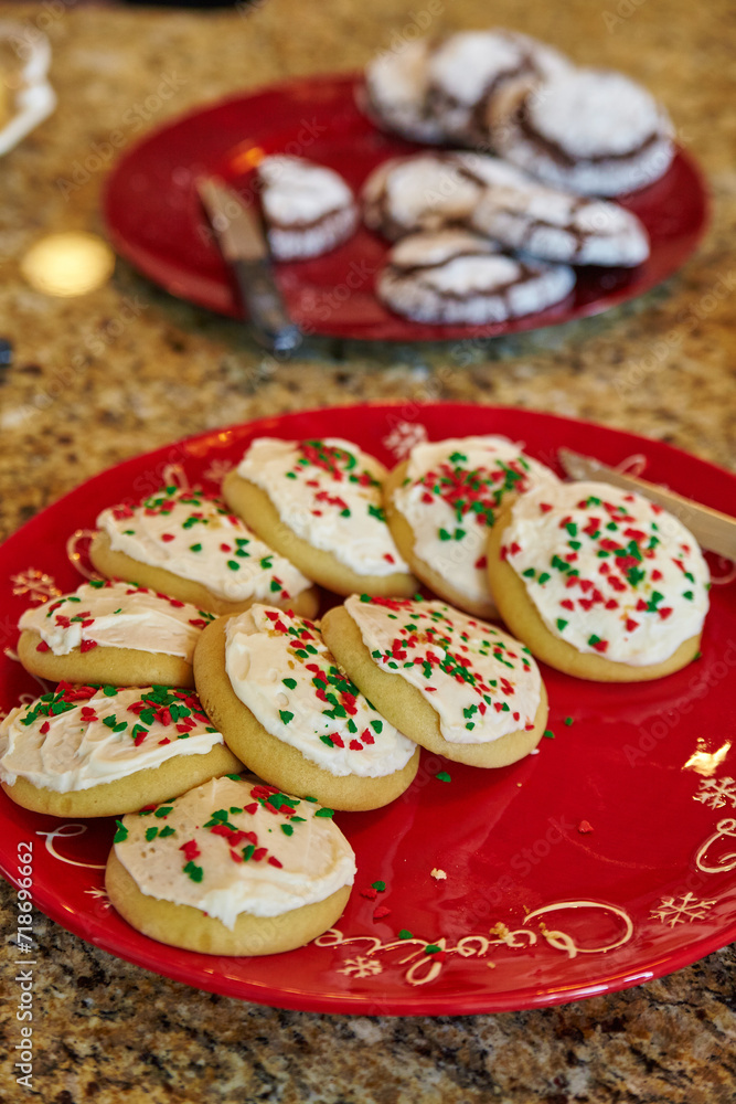 Festive Christmas Cookies on Red Plate with Holiday Decor Background