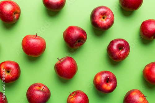 Many red apples on colored background, top view. Autumn pattern with fresh apple above view