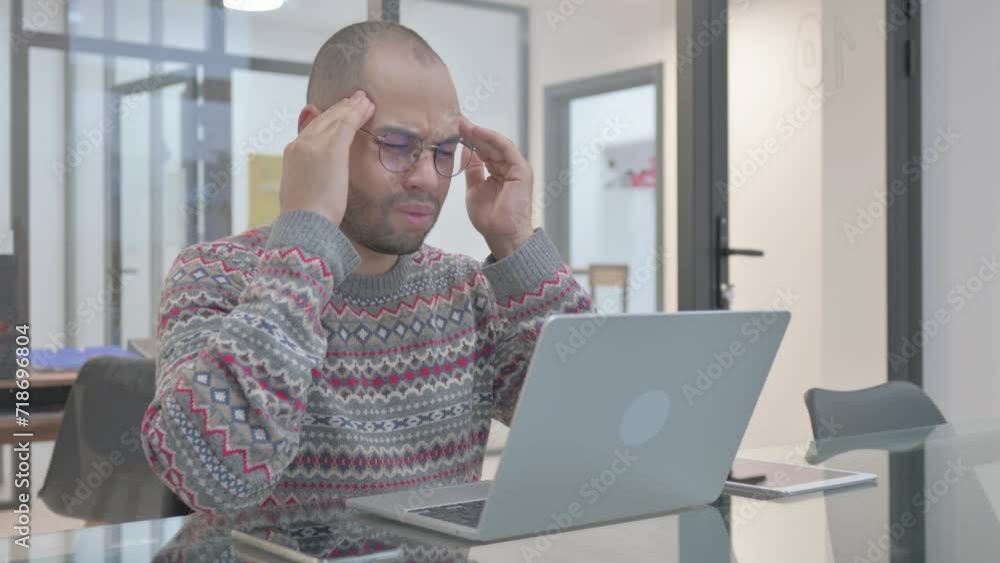 Young Hispanic Man having Headache at Work Young Hispanic Man having Headache at Work