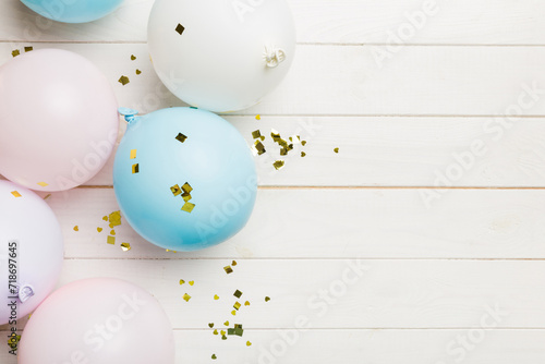 Background with fastive air balloons of round shape and confetti, multicoloured top view. Birthday party background