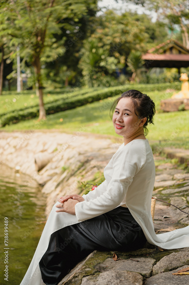 Portrait of Vietnamese woman in white ao dai outdoor