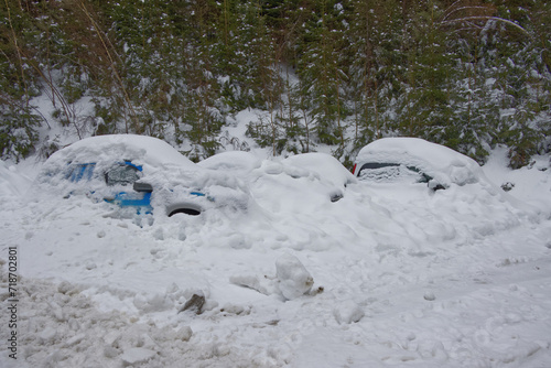 Frozen in winter, cars blanketed in heavy snow. © Robert