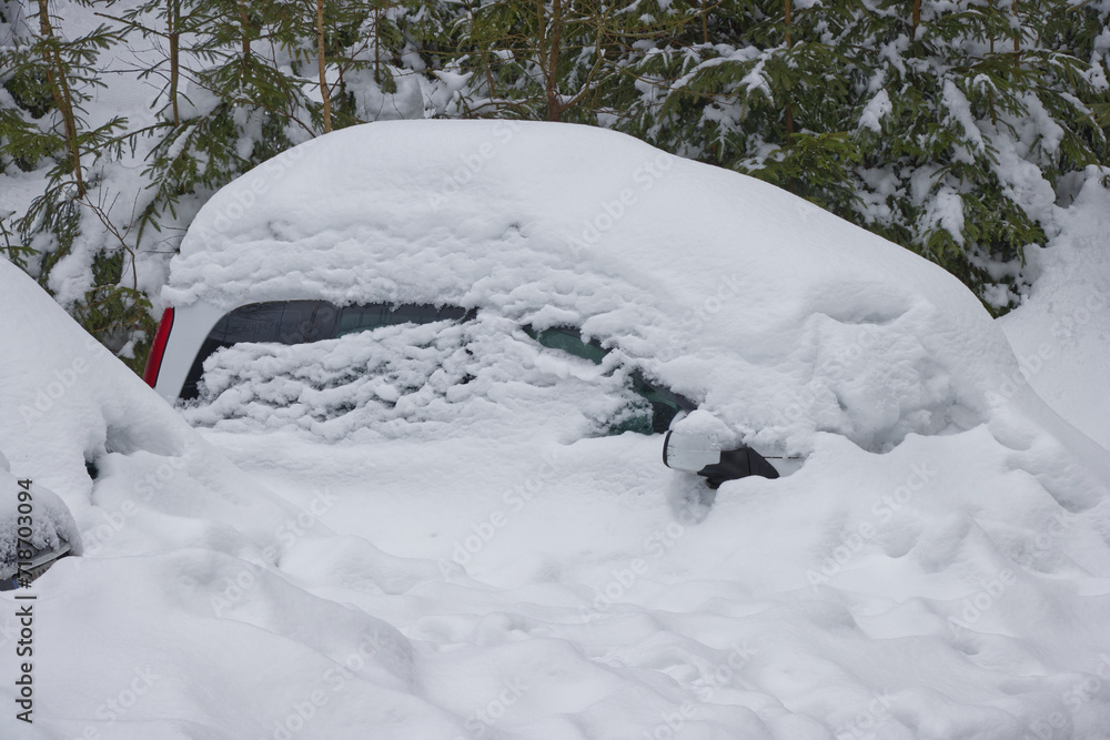 A car blanketed in heavy snow. A car blanketed in heavy snow.