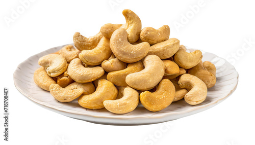 Roasted cashew nuts on white plate, isolated on transparent background