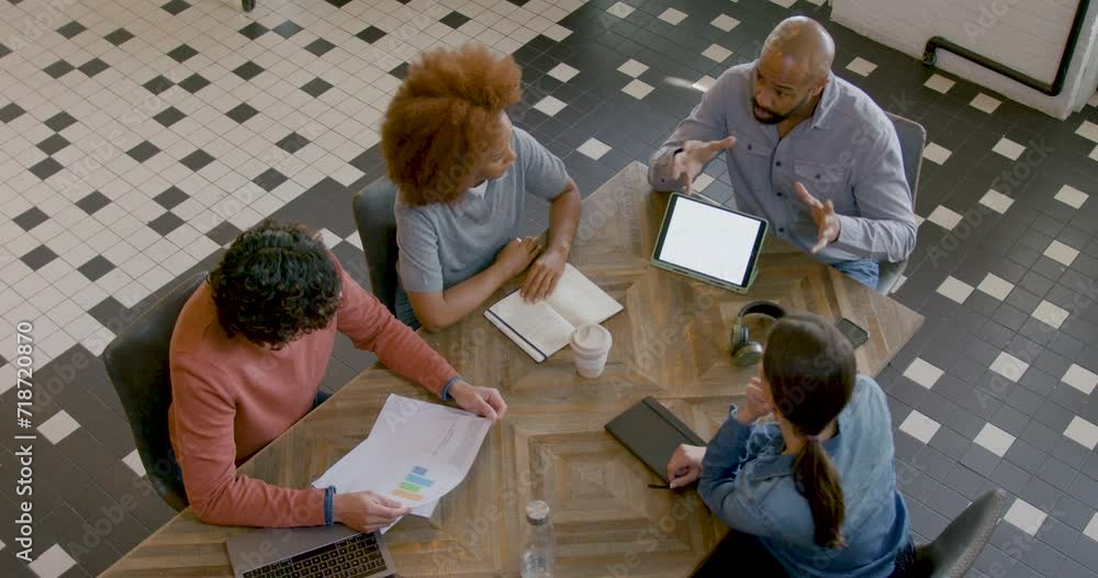 High Angle view of Business People Meeting at Table in Modern Office High Angle view of Business People Meeting at Table in Modern Office