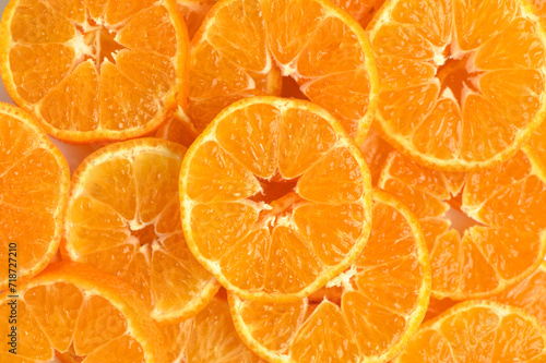 juicy and appetizing tangerines cut into circles as a food background 5