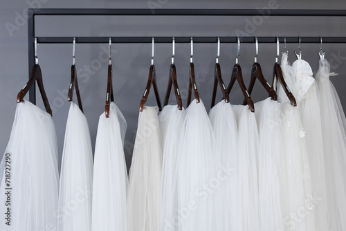 Wedding veil is hanging on a hanger in a wedding dress store.