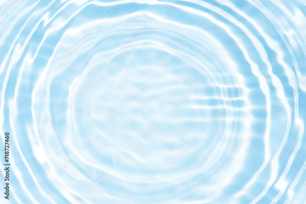 Bluewater waves on the surface ripples blurred. Defocus blurred transparent blue colored clear calm water surface texture with splash and bubbles. Water waves with shining pattern texture background. Bluewater waves on the surface ripples blurred. Defocus blurred transparent blue colored clear calm water surface texture with splash and bubbles. Water waves with shining pattern texture background.