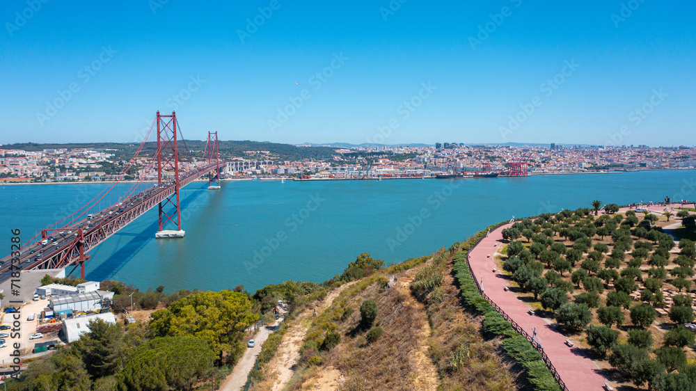 Aerial photo from drone to The 25 de Abril Suspension Bridge over Tagus river in Lisbon, the capital of Portugal. (Series)


