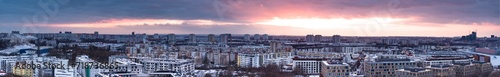 Aerial panorama of Poznan. Winter's Embrace: Sunset over Lake Malta, Poznań. A panoramic view of orange, purple, and navy hues illuminating the sky, with cityscape.