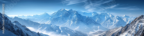 Snow-covered mountain range under a clear blue sky. Panoramic nature landscape for winter travel and tourism concept design  © Alexey