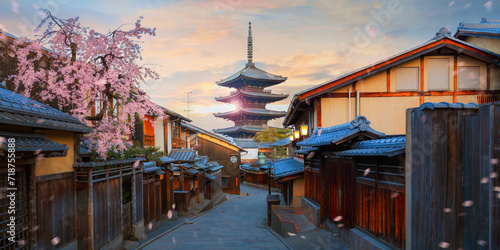 Scenic cityscape of Yasaka pagoda majestic sunset during full bloom cherry blossom and scatter sakura petals in Kyoto, Japan