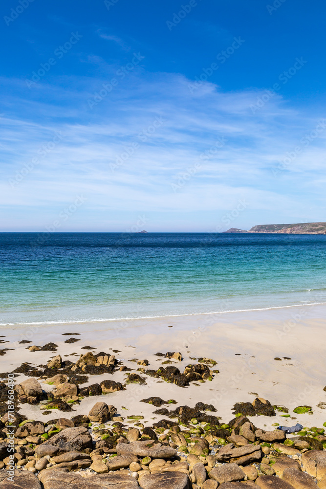 The sandy beach at Sennen in Cornwall, with a blue sky overhead The sandy beach at Sennen in Cornwall, with a blue sky overhead