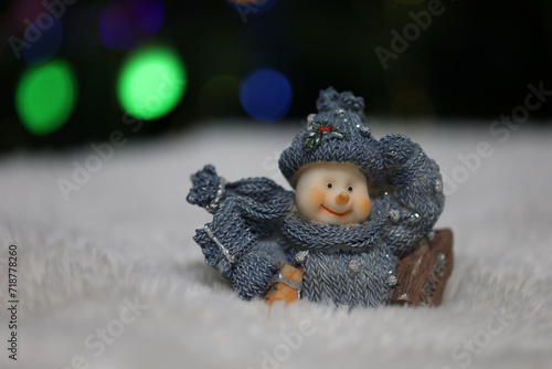 Snowman toy on table on christmas background