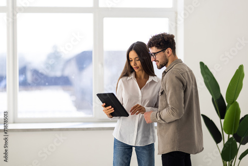 Young business colleagues in modern office using tablet