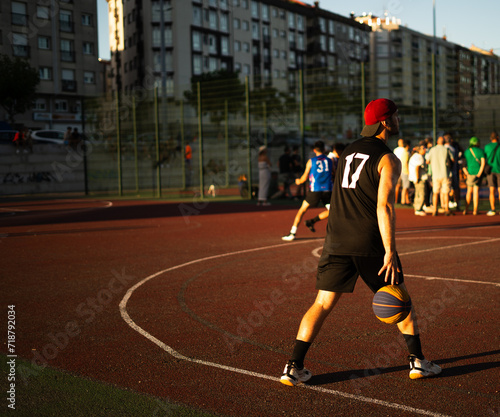 Fotografi Basketball player training on a court outdoors in summer days- 3x3 red cap